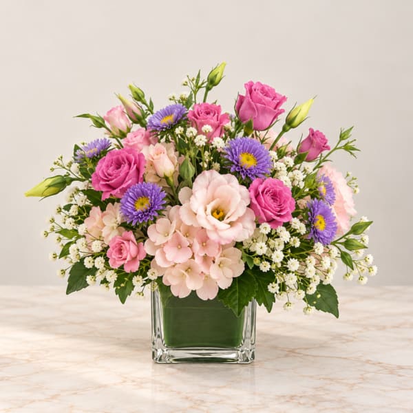 Pink and purple mixed bouquet in a clear glass vase