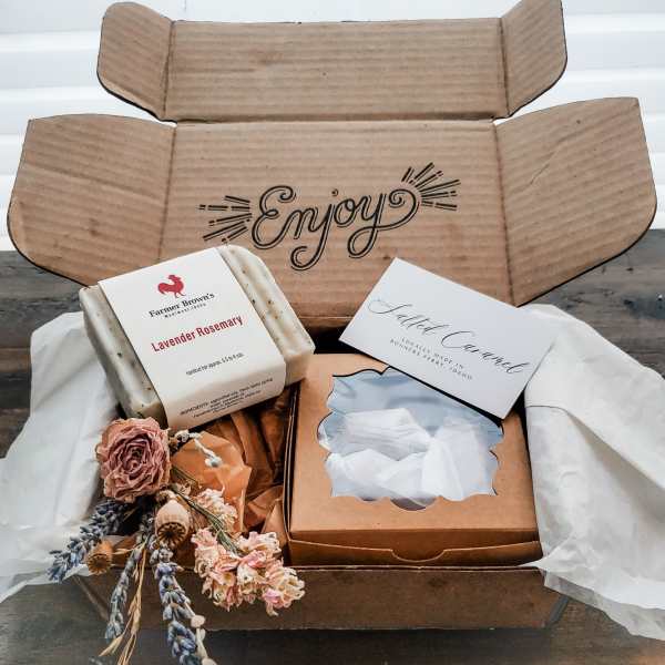 Gift box with soap bars, a candle, and dried flowers
