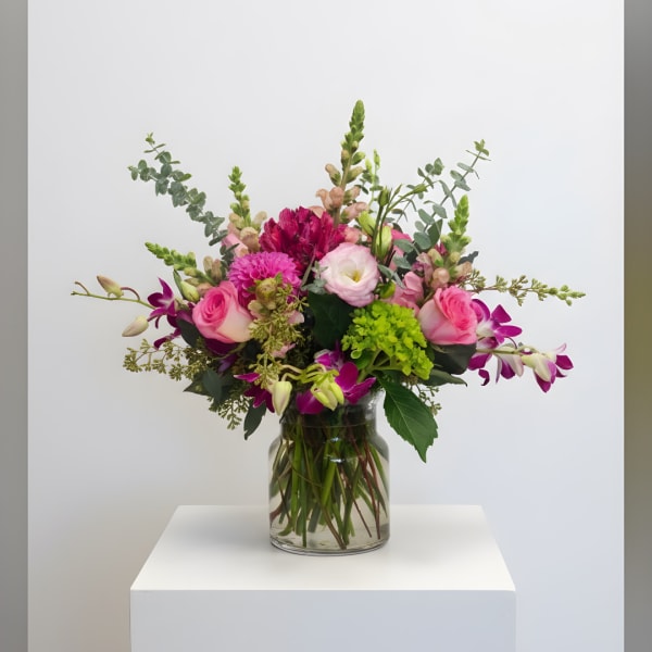 Pink and purple mixed bouquet in a clear glass vase