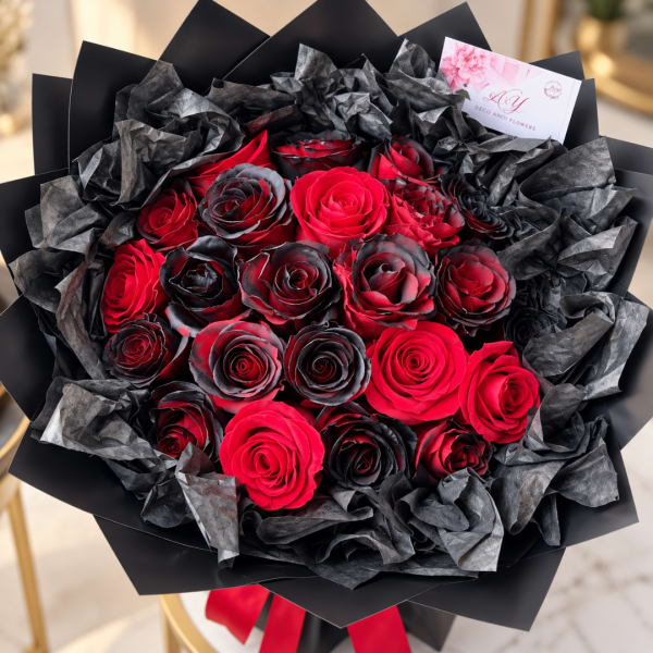 Bouquet of red and black roses wrapped in black paper