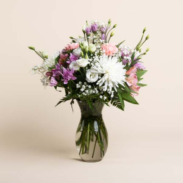 Mixed pink, white, and purple bouquet in a glass vase
