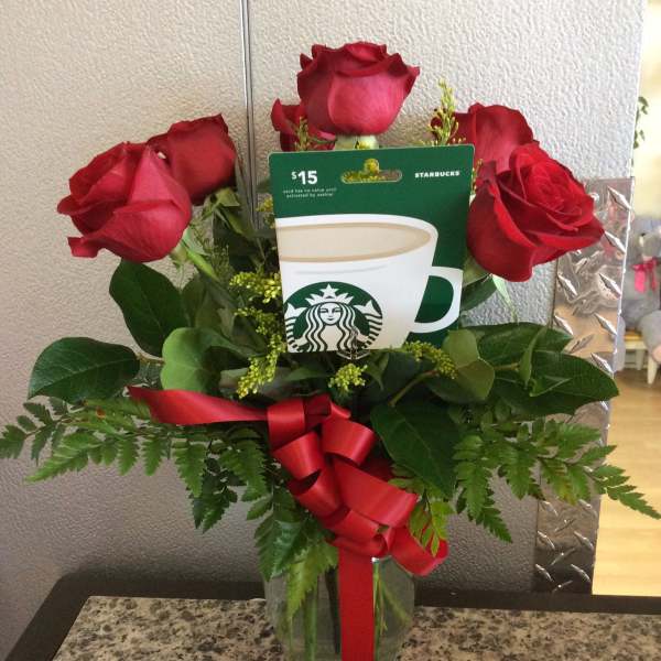Red roses in a glass vase with a Starbucks gift card and red ribbon