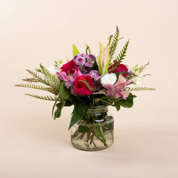 Mixed pink and white bouquet in a clear glass vase