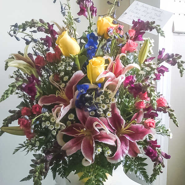 Large mixed bouquet with lilies, roses, and yellow tulips