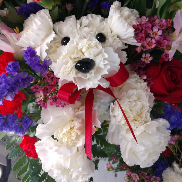 Bouquet with a white teddy bear made of carnations and a red ribbon