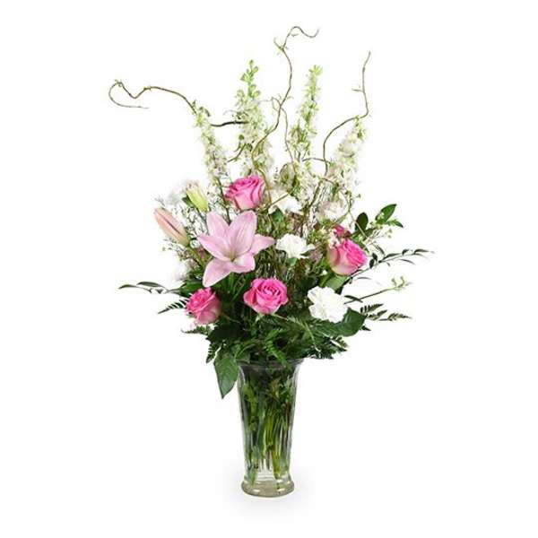 Pink roses and lilies in a clear glass vase
