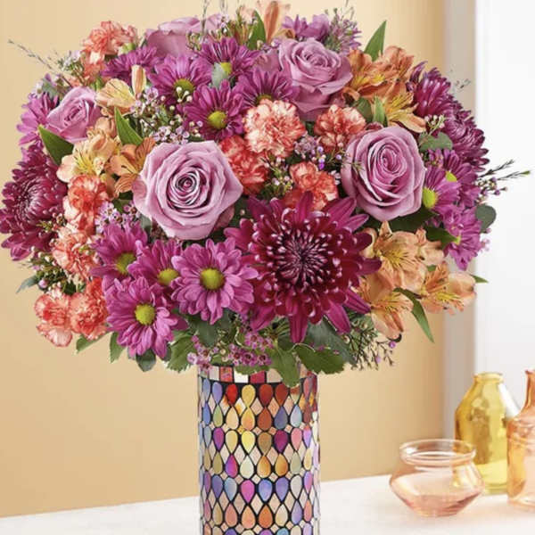 Bouquet of pink and purple flowers in a patterned vase