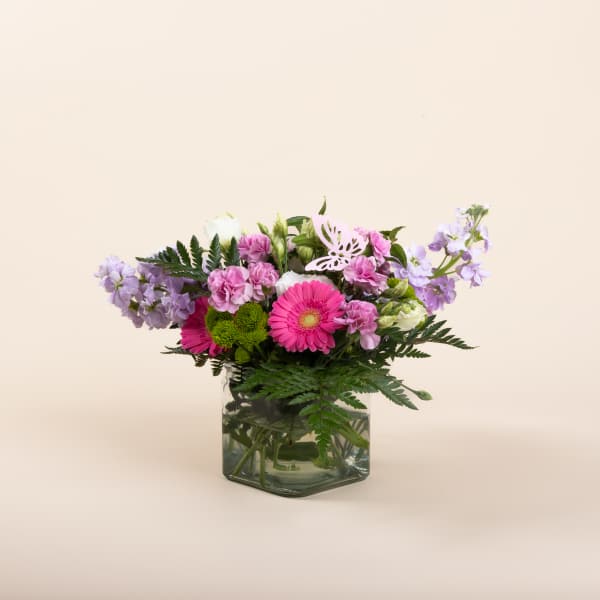 Pink and lavender mixed bouquet in a square glass vase