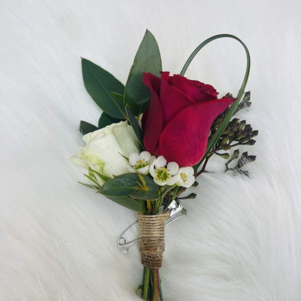 Red and white rose boutonniere with small white filler flowers