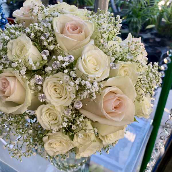 Bouquet of cream and blush roses with baby's breath