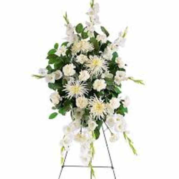 White floral standing spray on an easel