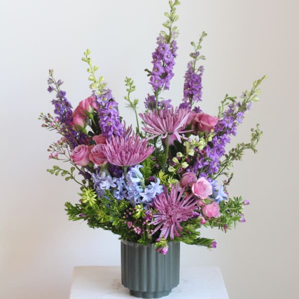Pink and purple mixed bouquet in a ribbed gray vase