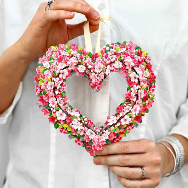 Heart-shaped floral ornament with pink and white blossoms