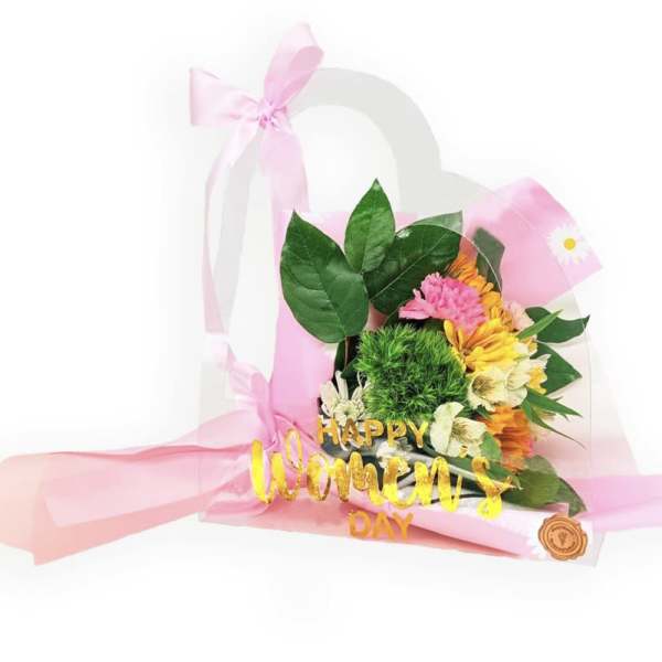Pink and yellow flower bouquet in a clear gift bag with a "Happy Women's Day" sign