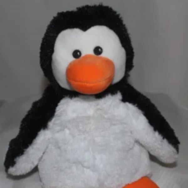 Plush penguin toy with orange beak and feet