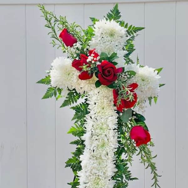 Standing floral cross with white flowers and red roses