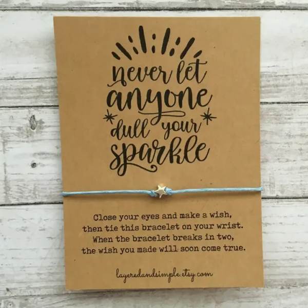 A kraft card with a wish bracelet and inspirational text