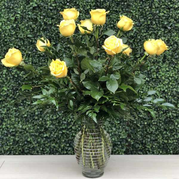 Yellow roses arranged in a clear glass vase