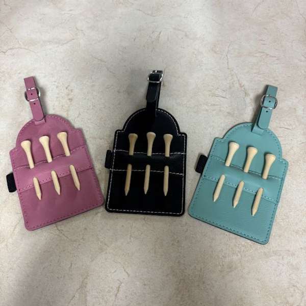 Three small leather pouches with buckles and bone-shaped pieces