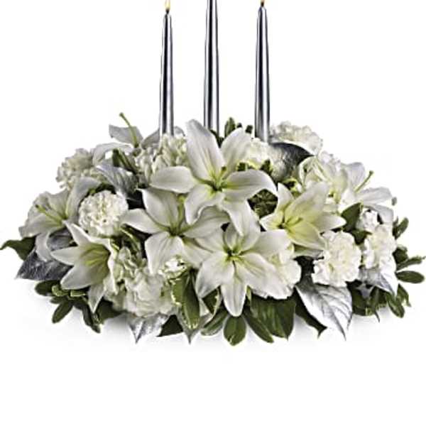 White floral centerpiece with three tall candles