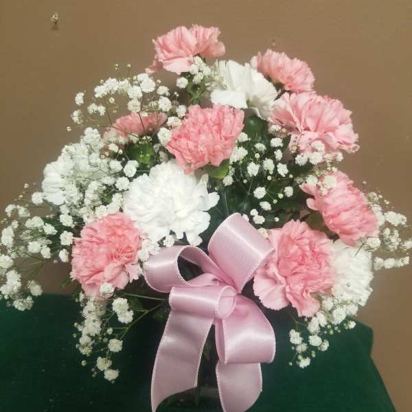Pink and white carnations with baby's breath and a pink ribbon bow