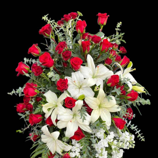 Red roses and white lilies arranged in a large bouquet
