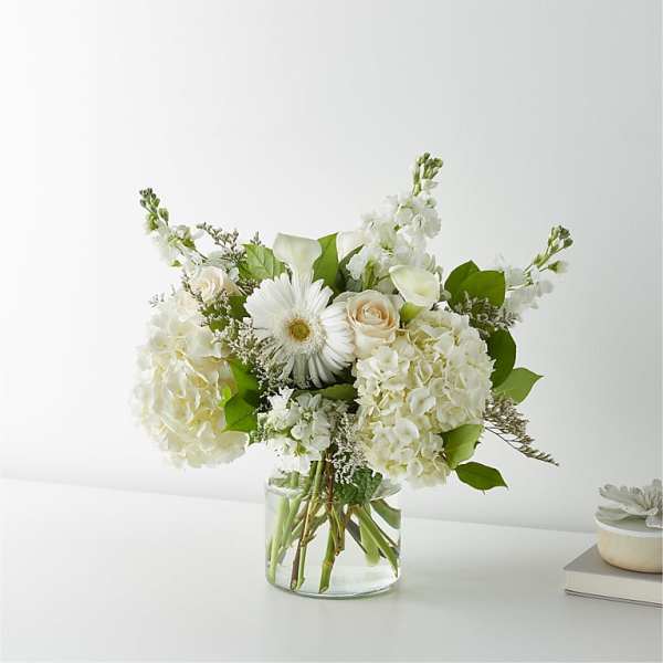 White floral arrangement in a clear glass vase