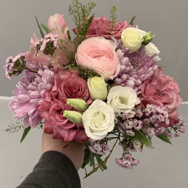 Handheld bouquet of pink and white flowers with lavender blooms