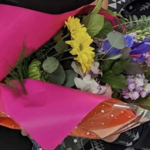 Mixed bouquet wrapped in bright pink and orange paper
