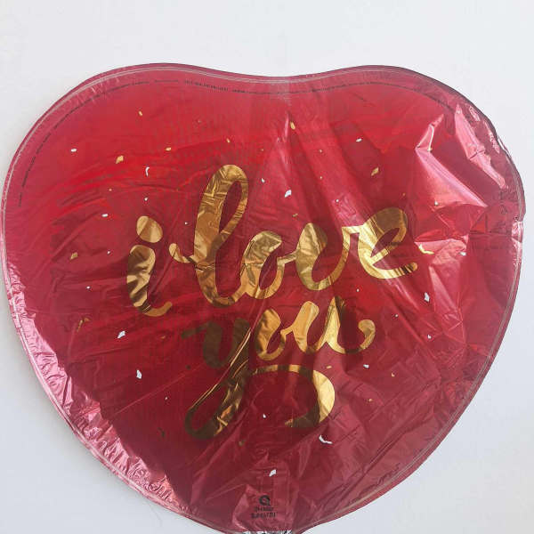Heart-shaped red balloon with gold "I love you" text