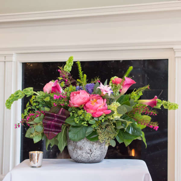 Pink and purple floral arrangement in a gray vase
