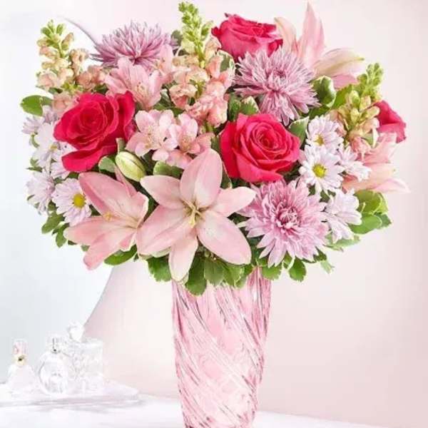 Pink and white mixed bouquet in a tall glass vase