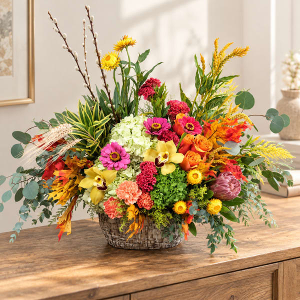 Colorful mixed flower arrangement in a woven basket