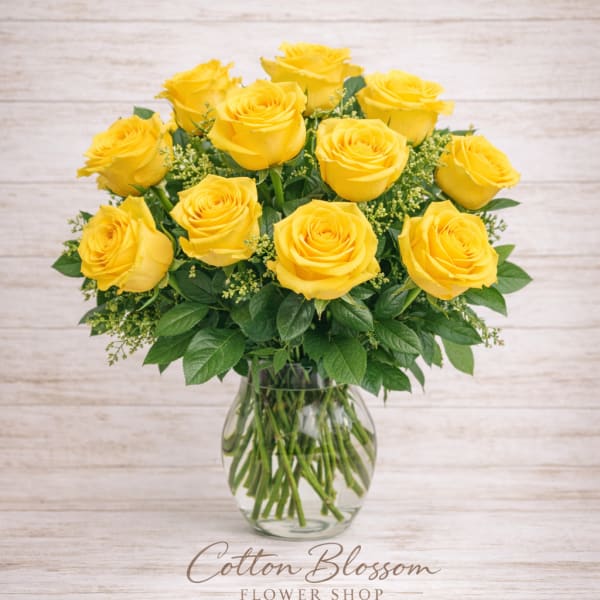 Yellow roses arranged in a clear glass vase