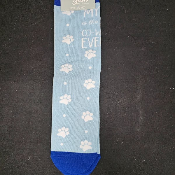 Light blue crew socks with white paw prints and blue toes