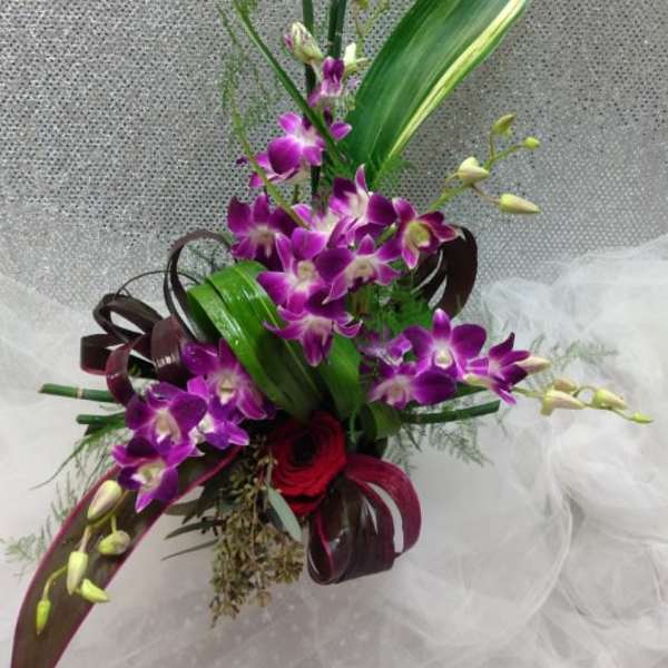 Tall bouquet with purple orchids and red roses