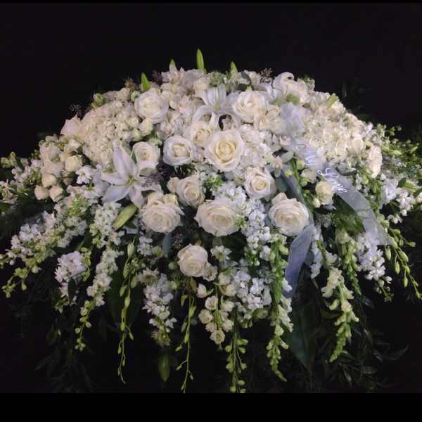 Large white floral spray with roses and lilies
