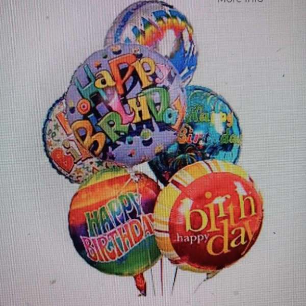 Cluster of colorful birthday balloons with printed messages