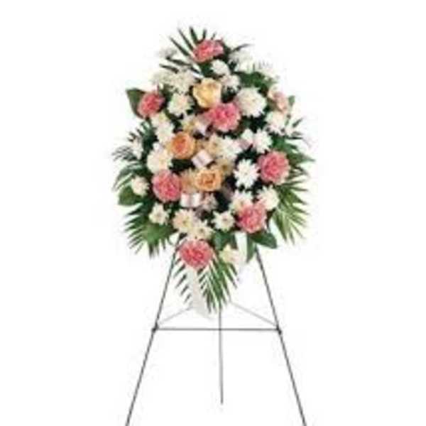 Standing floral spray with pink and white flowers on an easel
