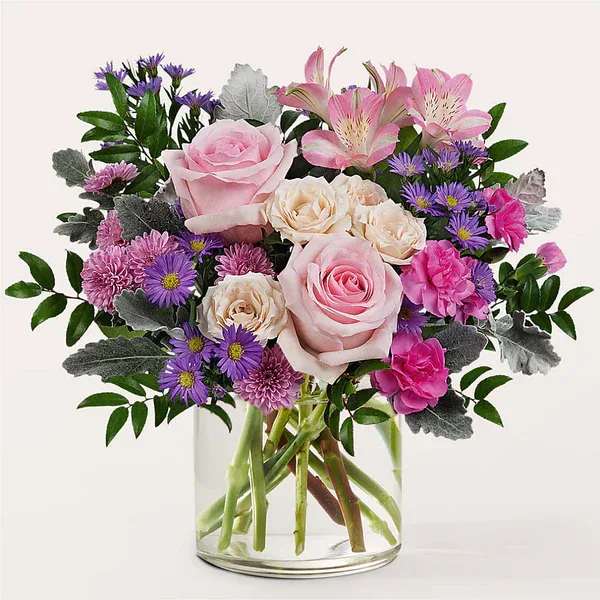 Pink and purple mixed bouquet in a clear glass vase