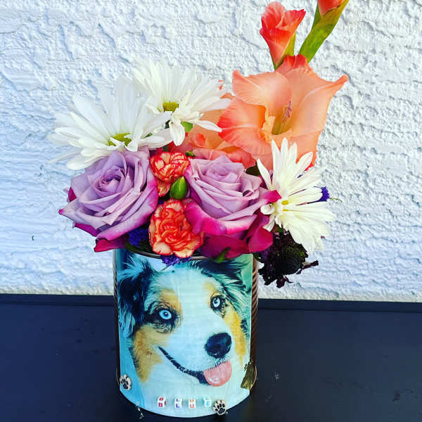 Colorful bouquet in a decorated tin with a dog illustration