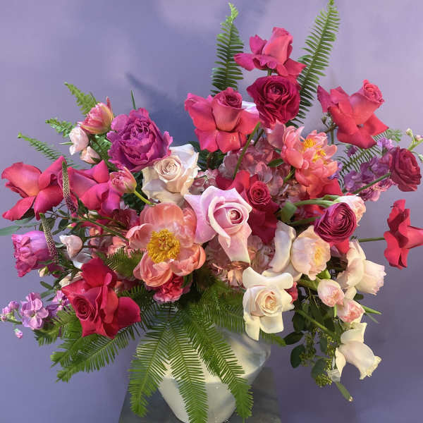 Pink and white mixed flower arrangement in a white vase