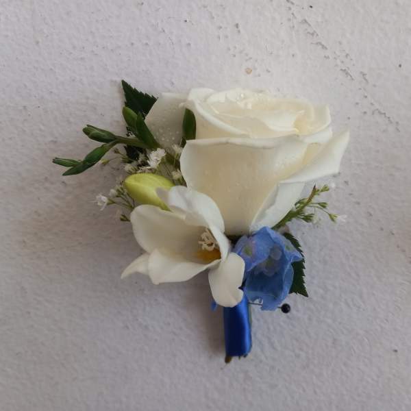 White rose boutonniere with a blue ribbon wrap