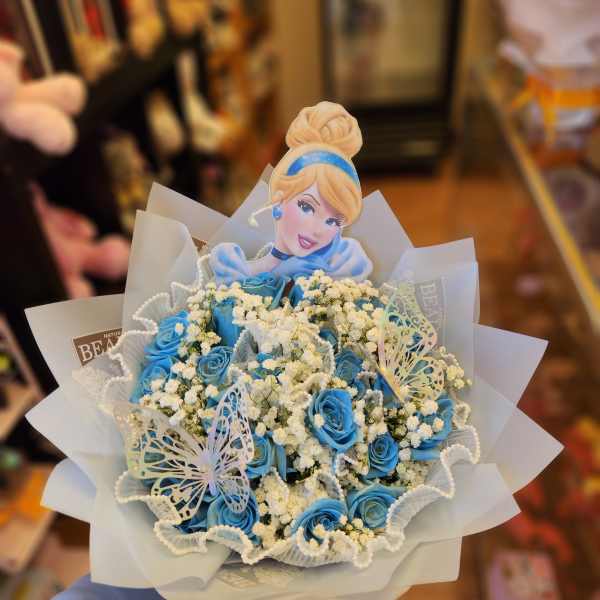 Blue rose bouquet with baby’s breath and a Cinderella topper