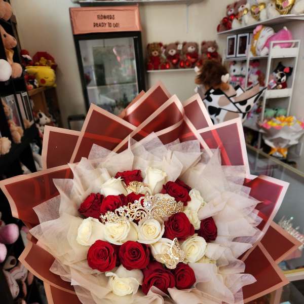 Bouquet of red and white roses wrapped in layered paper