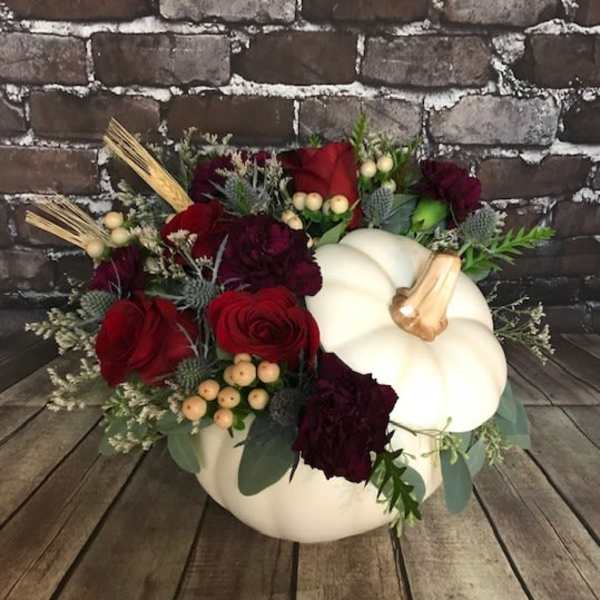 Pumpkin-shaped arrangement with red roses and burgundy flowers