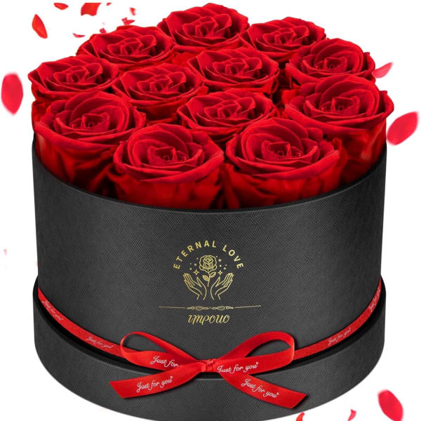 Red roses arranged in a black round gift box with a red ribbon