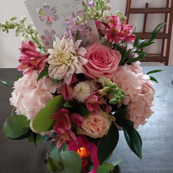 Pink and white mixed flower bouquet with a greeting card