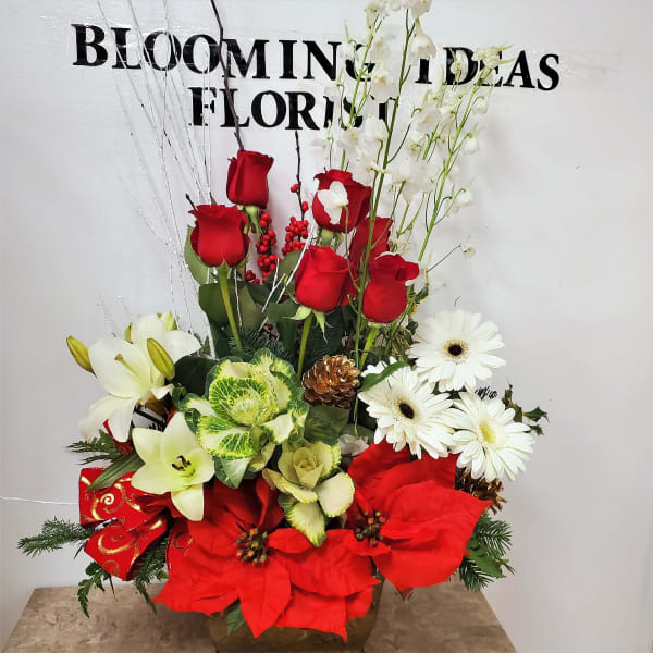 Red roses, white lilies, and white daisies in a decorative arrangement