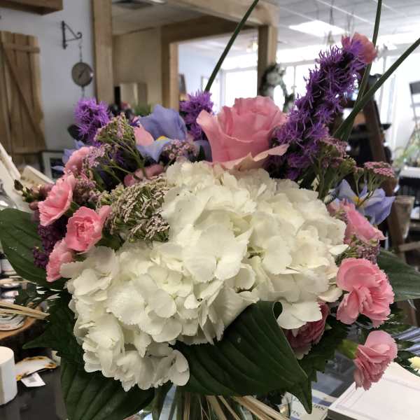 Bouquet of white hydrangeas with pink and purple flowers